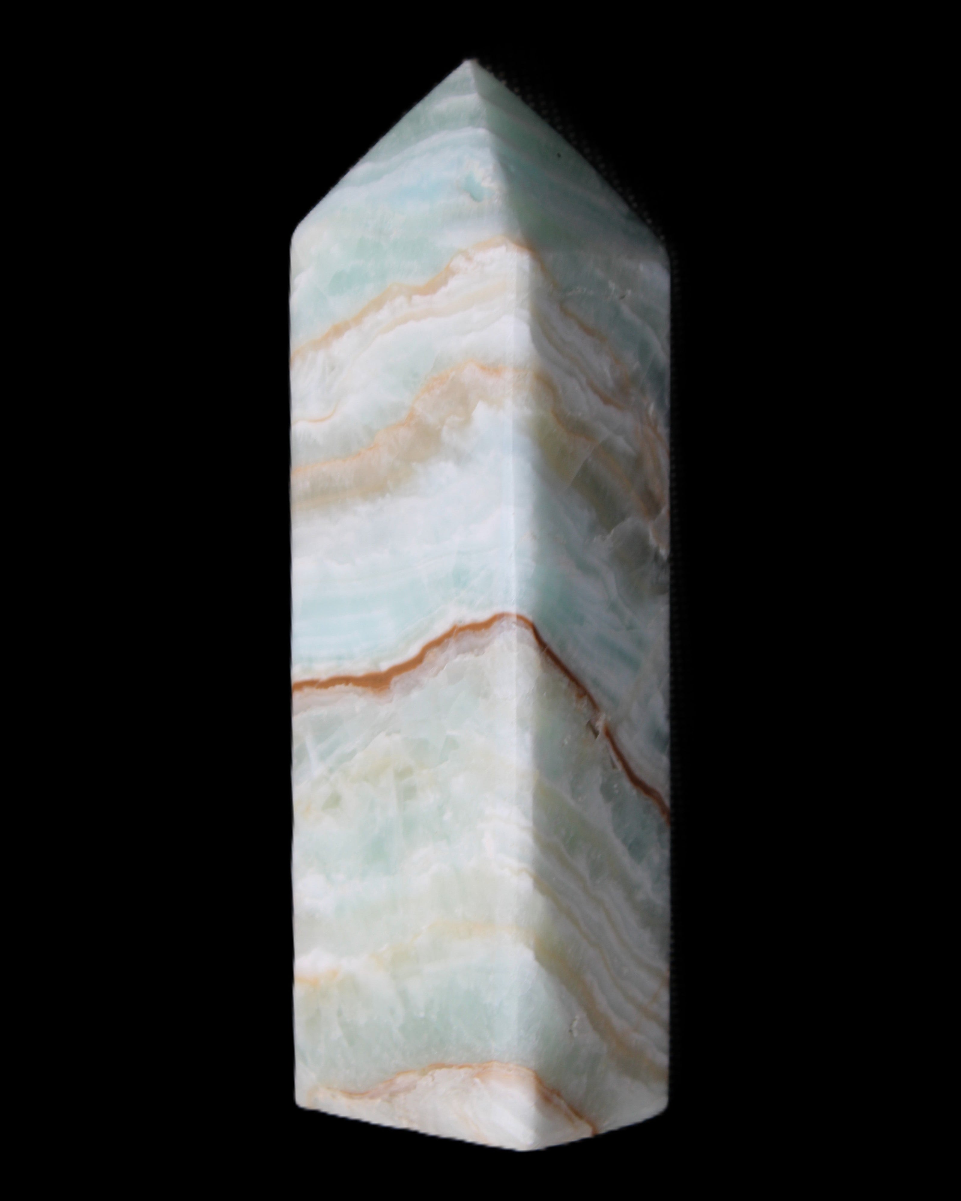 Pistachio Calcite obelisk 120mm 300g in sunlight - Rocks and Things Store