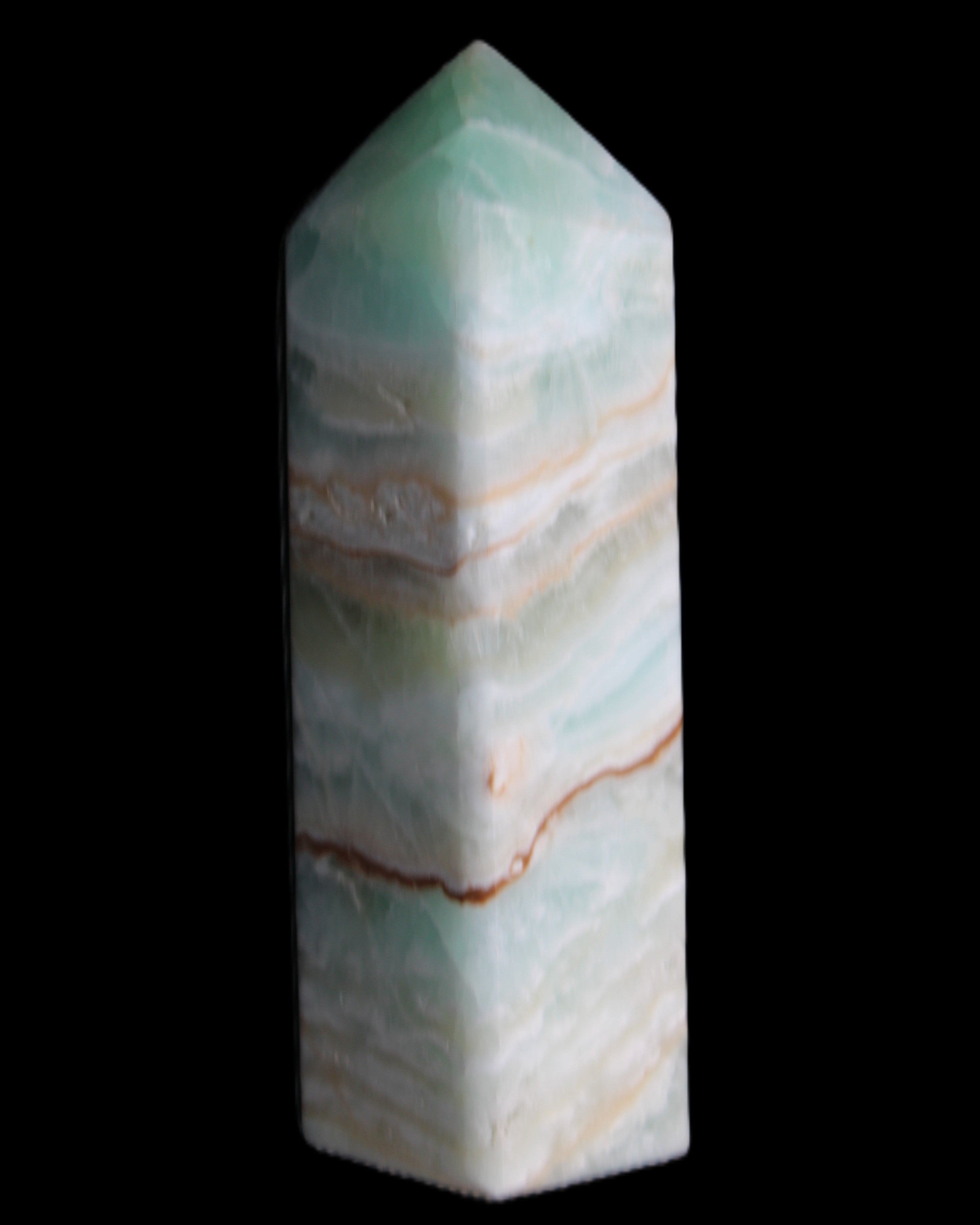 Pistachio Calcite obelisk 120mm 300g in sunlight - Rocks and Things Store