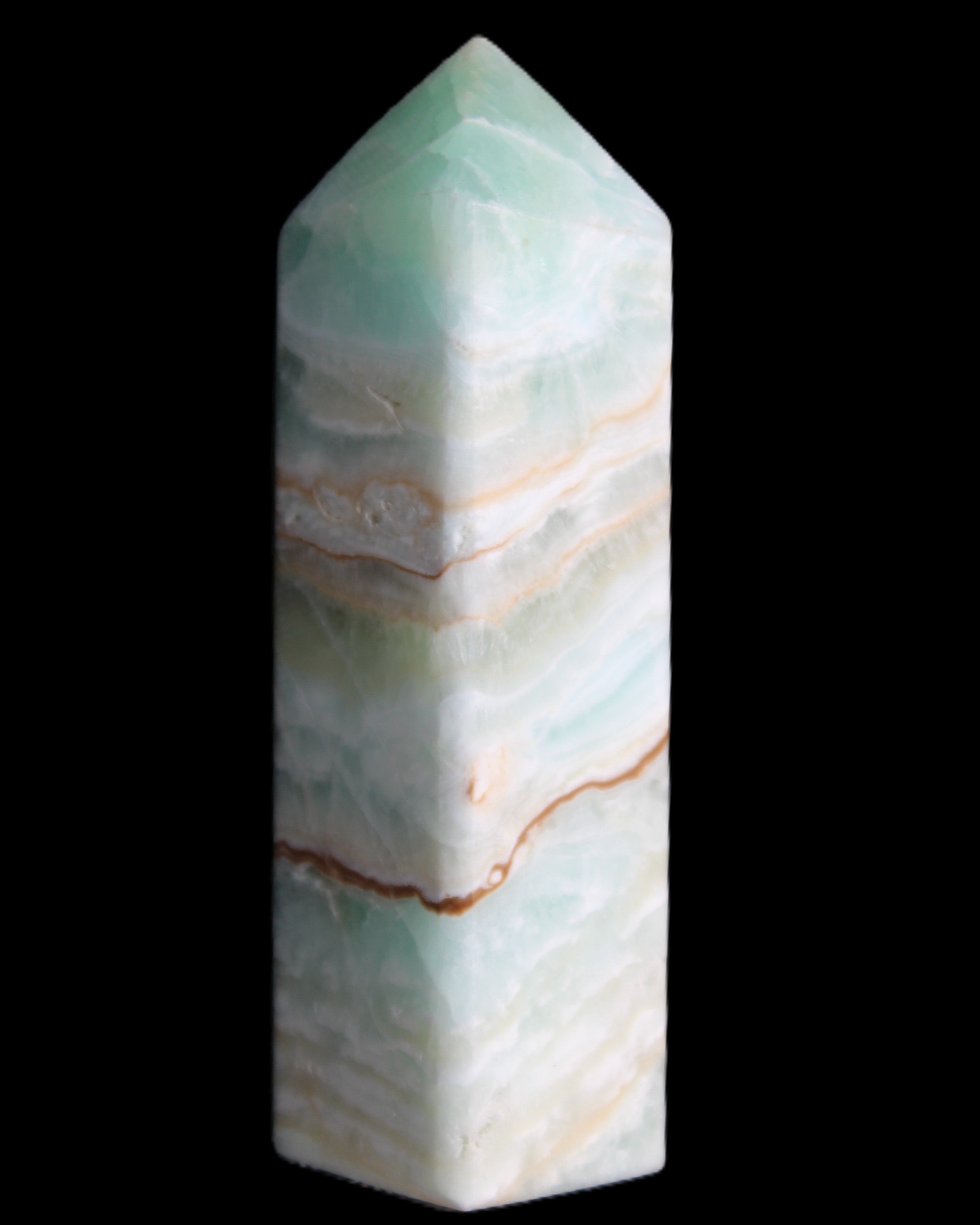 Pistachio Calcite obelisk 120mm 300g in sunlight - Rocks and Things Store