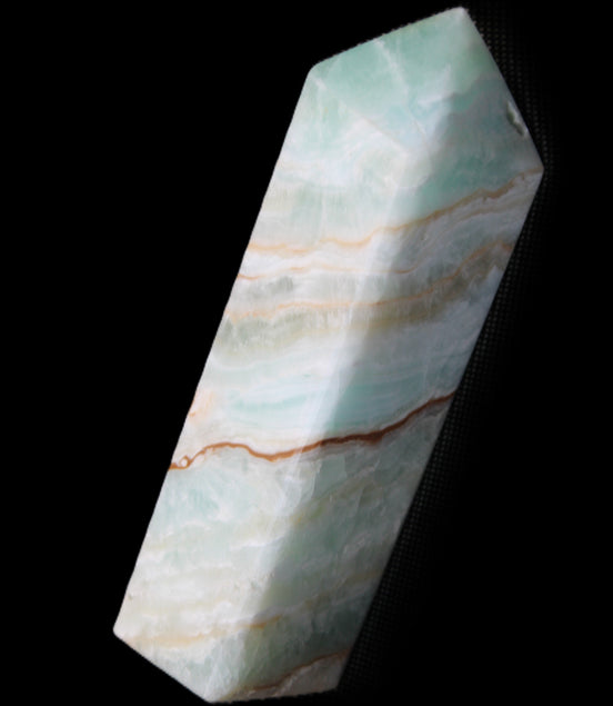 Pistachio Calcite obelisk 120mm 300g in sunlight - Rocks and Things Store
