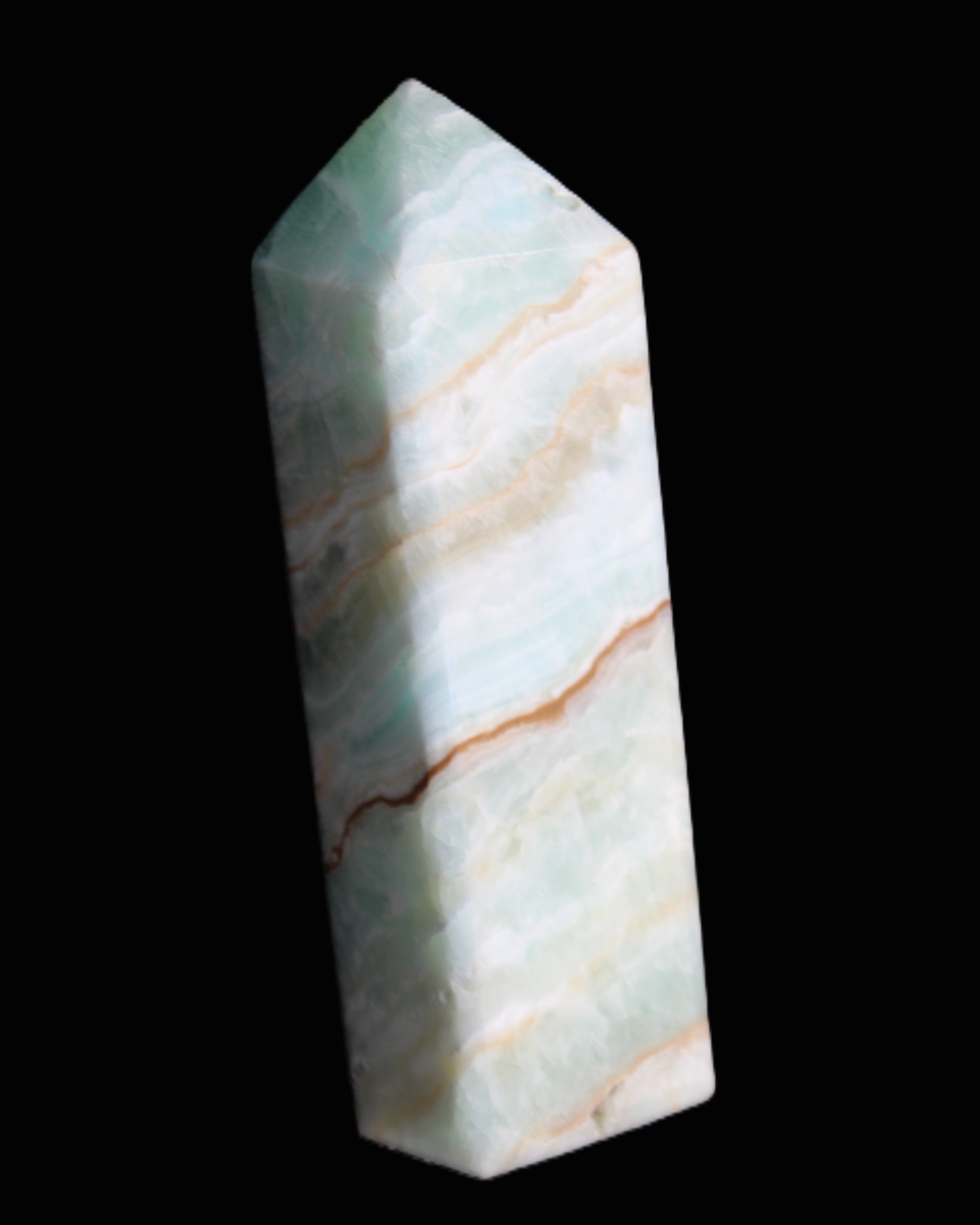Pistachio Calcite obelisk 120mm 300g in sunlight - Rocks and Things Store