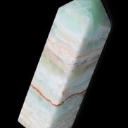 Pistachio Calcite obelisk 120mm 300g in sunlight - Rocks and Things Store
