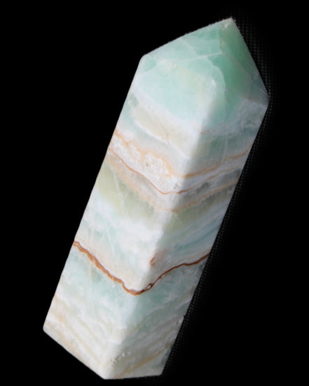 Pistachio Calcite obelisk 120mm 300g in sunlight - Rocks and Things Store