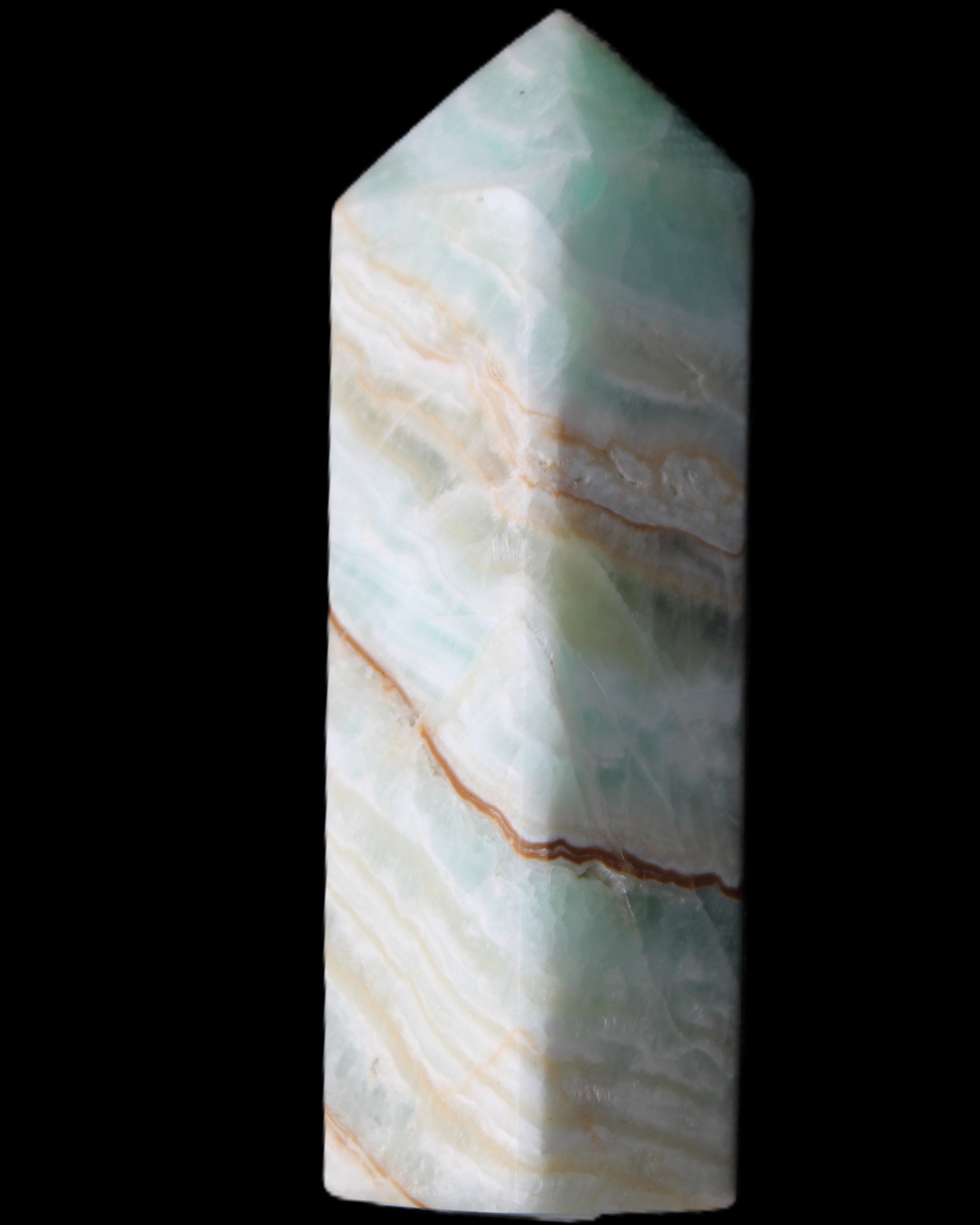 Pistachio Calcite obelisk 120mm 300g in sunlight - Rocks and Things Store