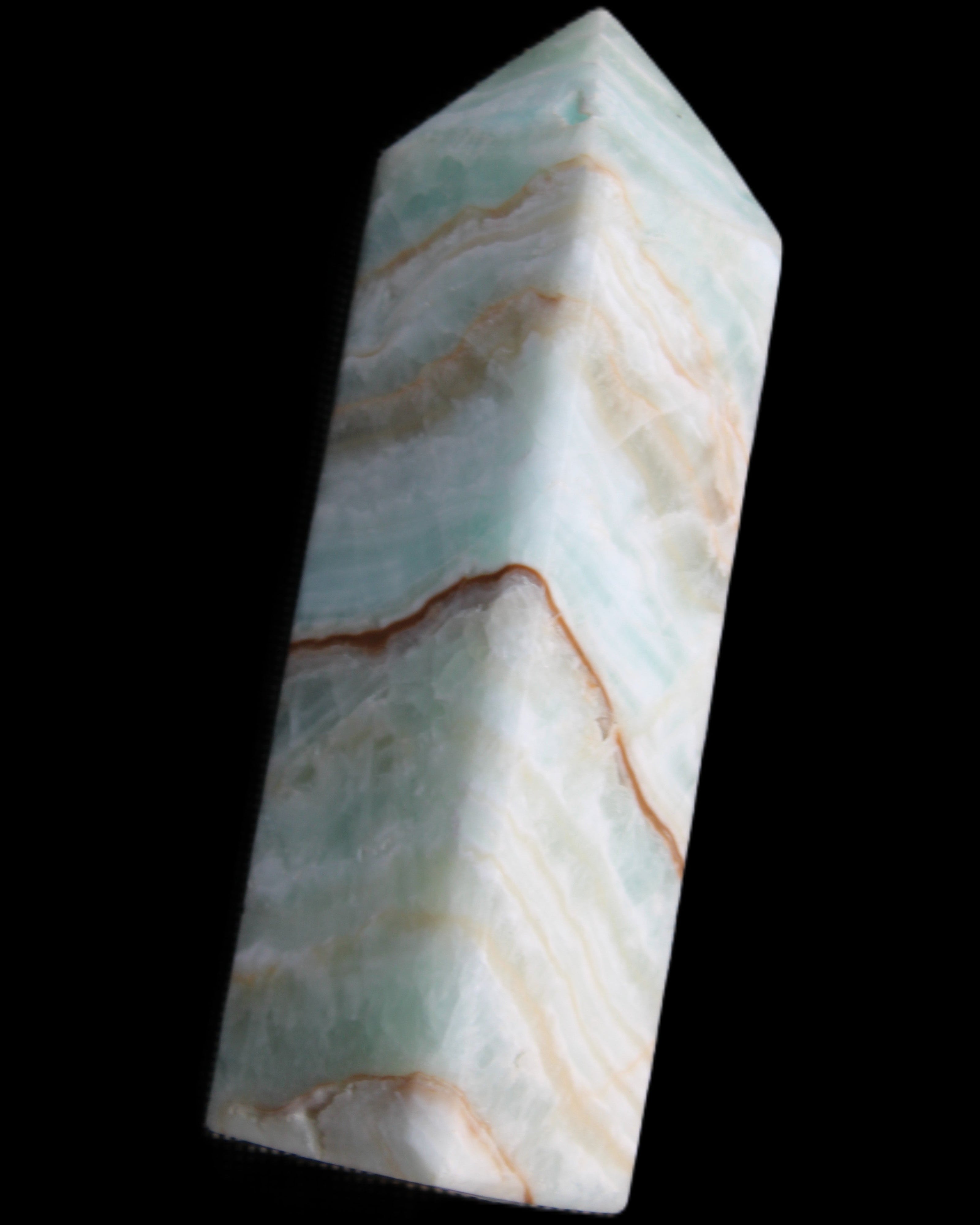 Pistachio Calcite obelisk 120mm 300g in sunlight - Rocks and Things Store