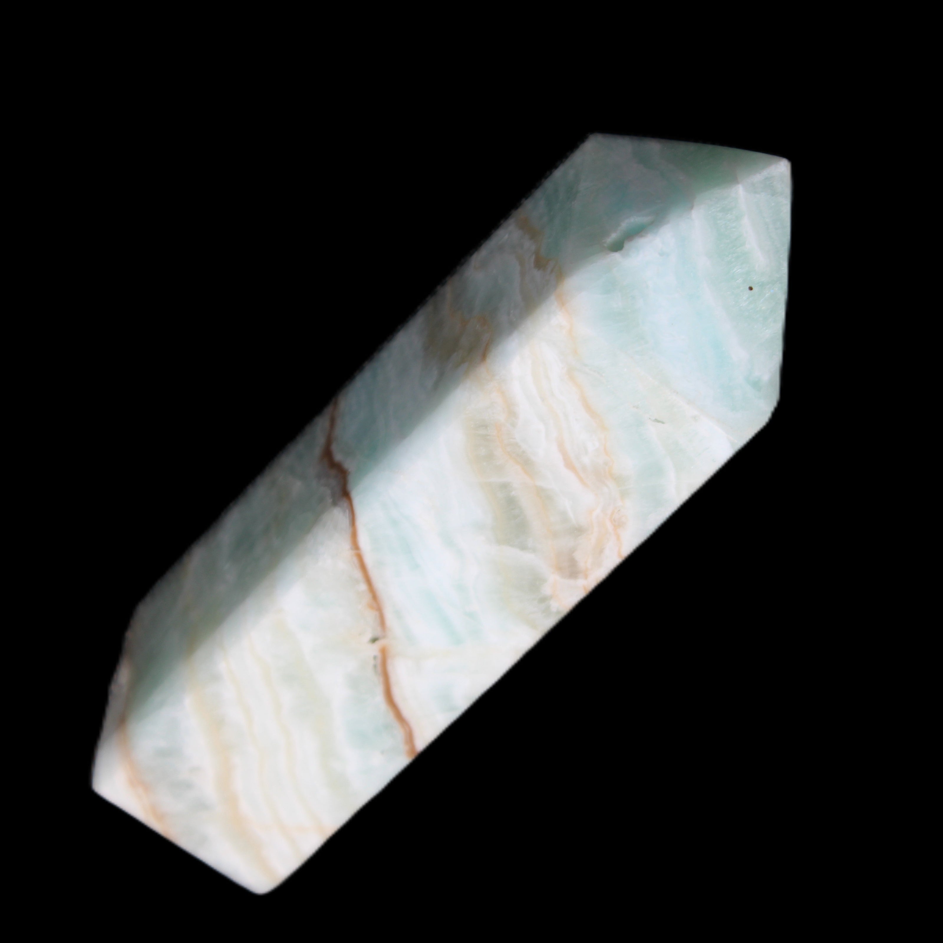 Pistachio Calcite obelisk 120mm 300g in sunlight - Rocks and Things Store