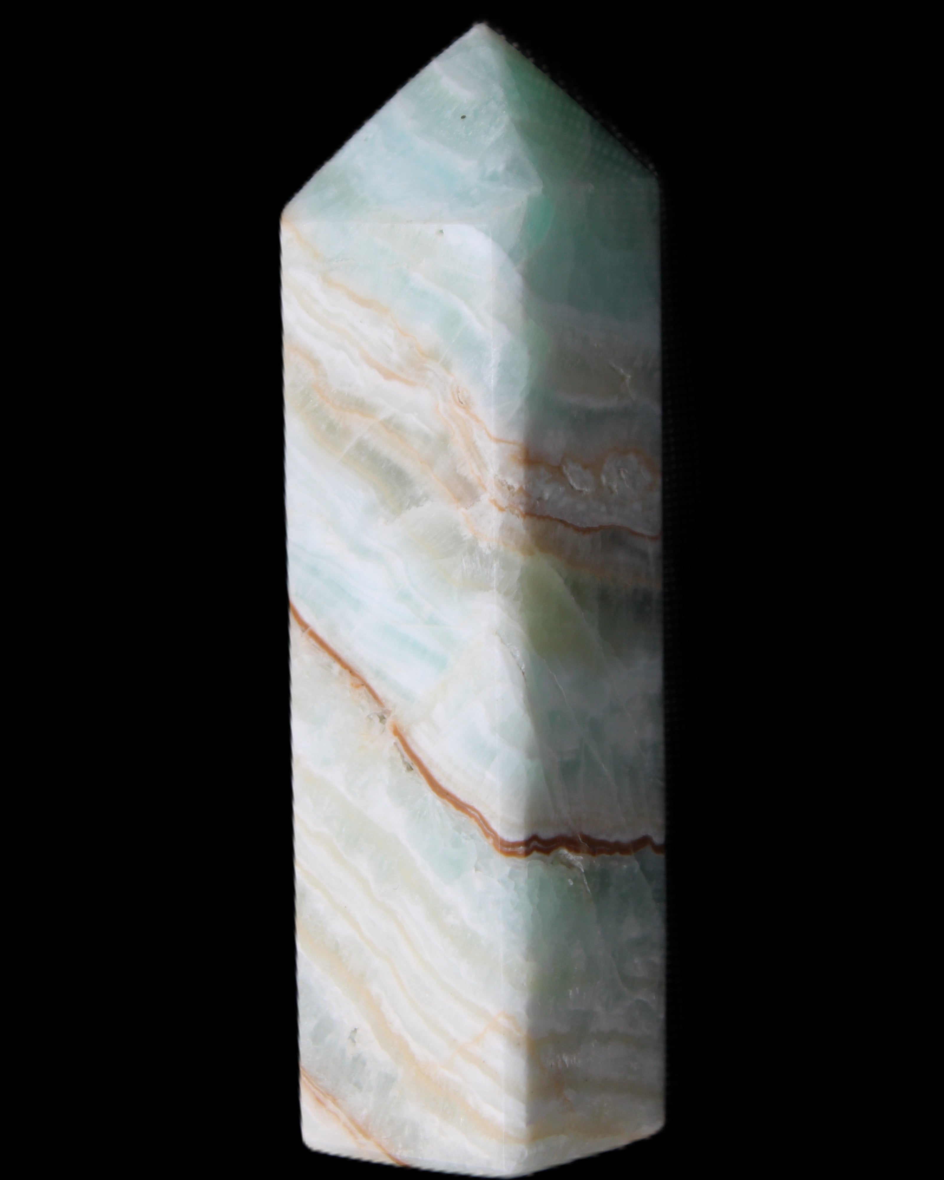 Pistachio Calcite obelisk 120mm 300g in sunlight - Rocks and Things Store