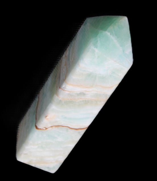 Pistachio Calcite obelisk 120mm 300g in sunlight - Rocks and Things Store