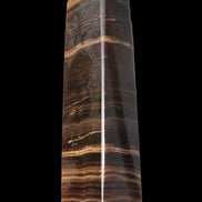 Chocolate Calcite obelisk 119*33 mm 222g in sunlight - Rocks and Things Store