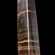 Chocolate Calcite obelisk 119*33 mm 222g in sunlight - Rocks and Things Store