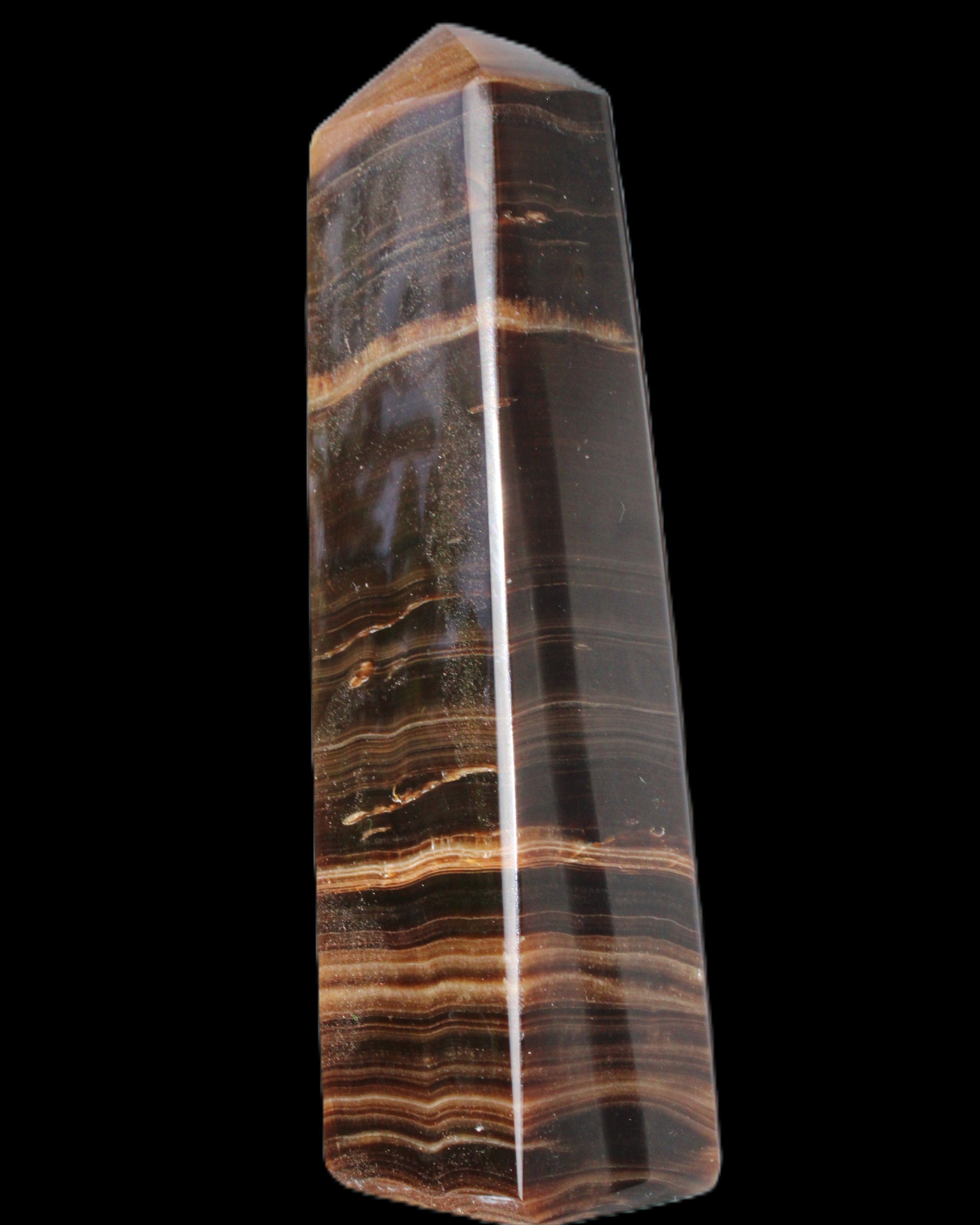 Chocolate Calcite obelisk 119*33 mm 222g in sunlight - Rocks and Things Store