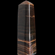 Chocolate Calcite obelisk 119*33 mm 222g in sunlight - Rocks and Things Store