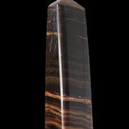 Chocolate Calcite obelisk 119*33 mm 222g in sunlight - Rocks and Things Store