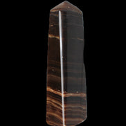 Chocolate Calcite obelisk 119*33 mm 222g in sunlight - Rocks and Things Store