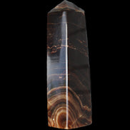 Chocolate Calcite obelisk 136*36mm 366g in sunlight - Rocks and Things Store