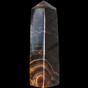 Chocolate Calcite obelisk 136*36mm 366g in sunlight - Rocks and Things Store