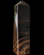Chocolate Calcite obelisk 136*36mm 366g in sunlight - Rocks and Things Store