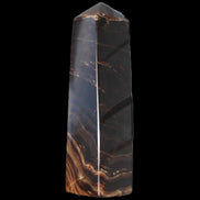 Chocolate Calcite obelisk 136*36mm 366g in sunlight - Rocks and Things Store