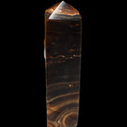 Chocolate Calcite obelisk 136*36mm 366g in sunlight - Rocks and Things Store
