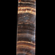 Chocolate Calcite obelisk 122*33mm 270g in sunlight - Rocks and Things Store