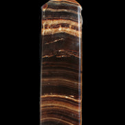 Chocolate Calcite obelisk 122*33mm 270g in sunlight - Rocks and Things Store