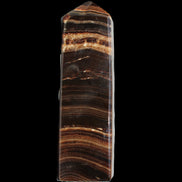Chocolate Calcite obelisk 122*33mm 270g in sunlight - Rocks and Things Store