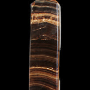 Chocolate Calcite obelisk 122*33mm 270g in sunlight - Rocks and Things Store