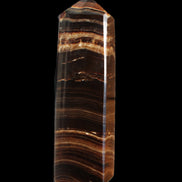 Chocolate Calcite obelisk 122*33mm 270g in sunlight - Rocks and Things Store