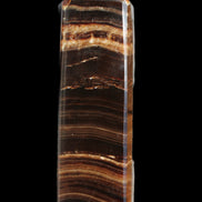 Chocolate Calcite obelisk 122*33mm 270g in sunlight - Rocks and Things Store