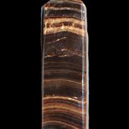 Chocolate Calcite obelisk 122*33mm 270g in sunlight - Rocks and Things Store