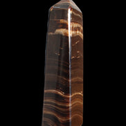 Chocolate Calcite obelisk 122*33mm 270g in sunlight - Rocks and Things Store