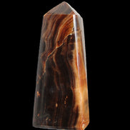 Chocolate Calcite obelisk 106*43mm 303g in sunlight - Rocks and Things Store
