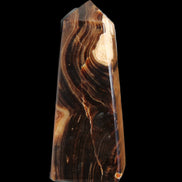 Chocolate Calcite obelisk 106*43mm 303g in sunlight - Rocks and Things Store