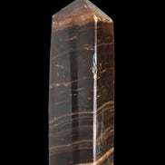 Chocolate Calcite obelisk 108*32mm 216g in sunlight - Rocks and Things Store