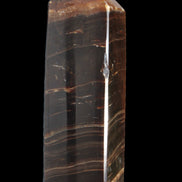 Chocolate Calcite obelisk 108*32mm 216g in sunlight - Rocks and Things Store