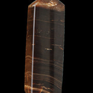 Chocolate Calcite obelisk 108*32mm 216g in sunlight - Rocks and Things Store