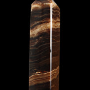 Chocolate Calcite obelisk 116*32mm 243g in sunlight - Rocks and Things Store