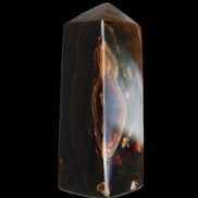 Chocolate Calcite obelisk 91*34mm 211g in sunlight - Rocks and Things Store