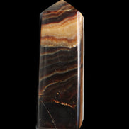 Chocolate Calcite obelisk 103*35mm 268g in sunlight - Rocks and Things Store