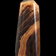 Chocolate Calcite obelisk 103*35mm 268g in sunlight - Rocks and Things Store