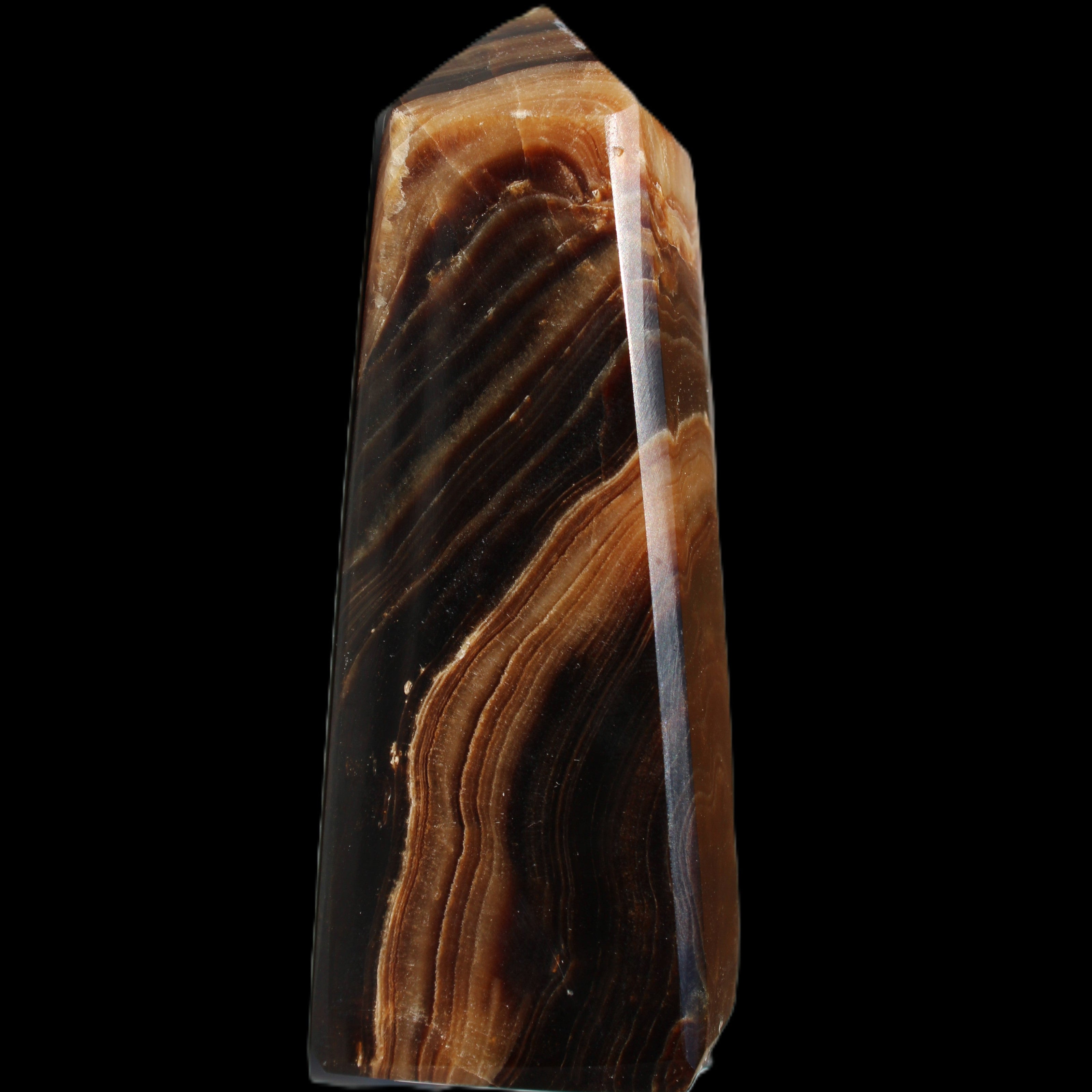 Chocolate Calcite obelisk 103*35mm 268g in sunlight - Rocks and Things Store