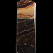 Chocolate Calcite obelisk 103*35mm 268g in sunlight - Rocks and Things Store