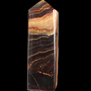 Chocolate Calcite obelisk 103*35mm 268g in sunlight - Rocks and Things Store