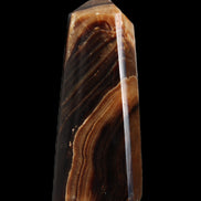 Chocolate Calcite obelisk 103*35mm 268g in sunlight - Rocks and Things Store