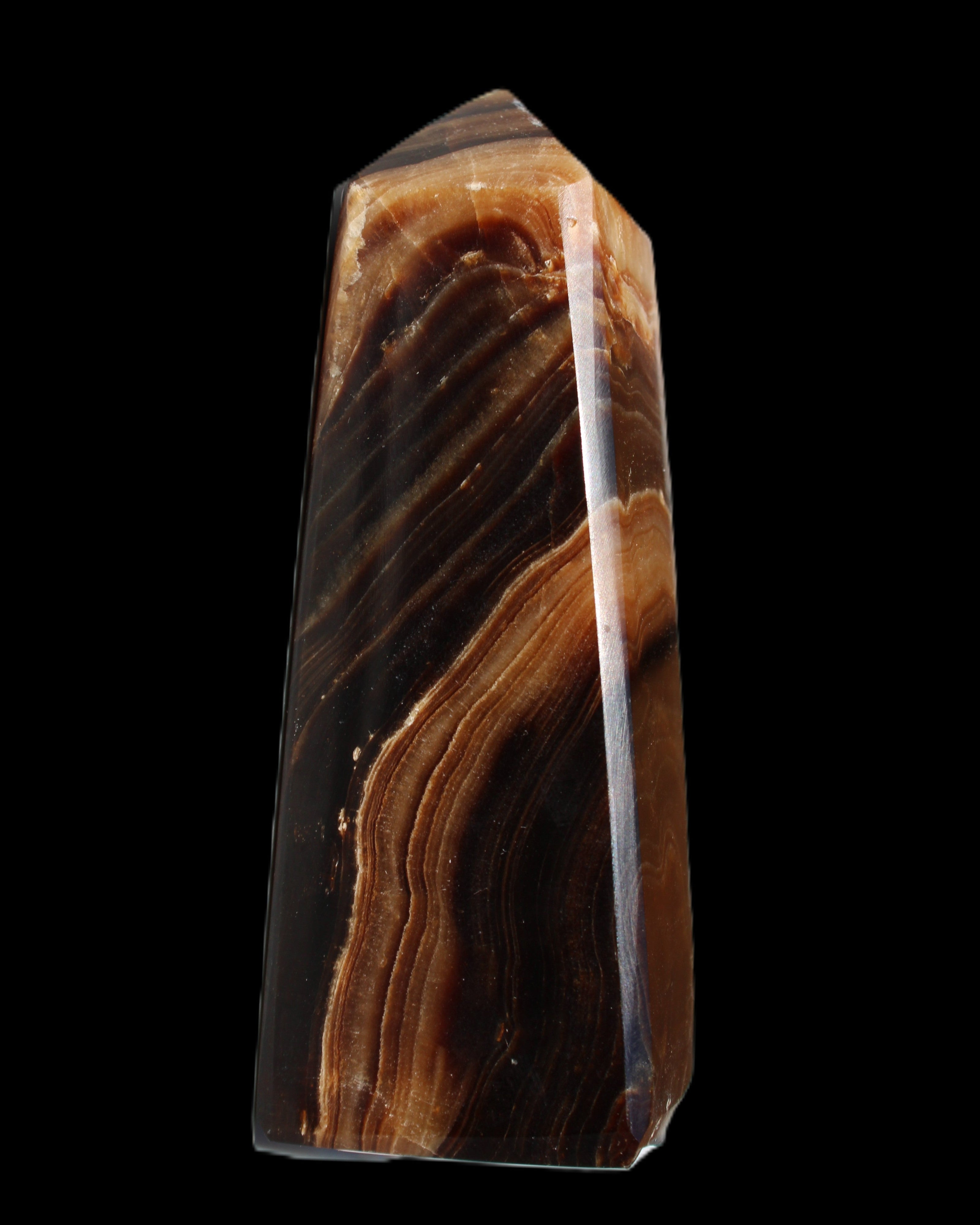 Chocolate Calcite obelisk 103*35mm 268g in sunlight - Rocks and Things Store