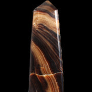 Chocolate Calcite obelisk 103*35mm 268g in sunlight - Rocks and Things Store