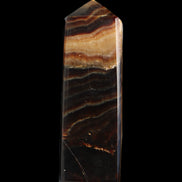 Chocolate Calcite obelisk 103*35mm 268g in sunlight - Rocks and Things Store