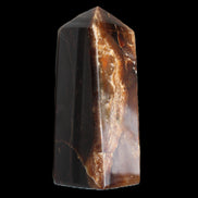 Chocolate Calcite obelisk 100*40mm 286g in sunlight - Rocks and Things Store