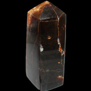 Chocolate Calcite obelisk 100*40mm 286g in sunlight - Rocks and Things Store