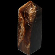 Chocolate Calcite obelisk 100*40mm 286g in sunlight - Rocks and Things Store